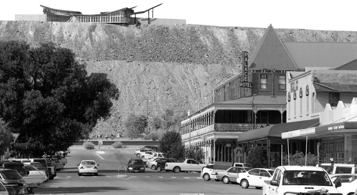 Black and White photo shopwing Broken Hill Mullock Heap with Main Street and Zpalace Hotel int he foreground